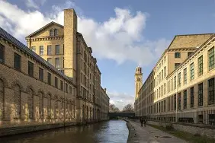 Industrial stone-built buildings either side of a canal